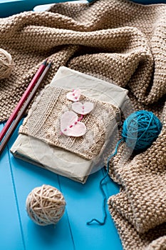 One old notebook in knitted cover with felt hearts