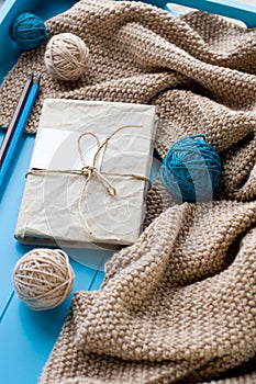 One old notebook in knitted cover lie next to the coil