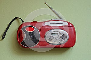 One old red mini mobile tape recorder with radio