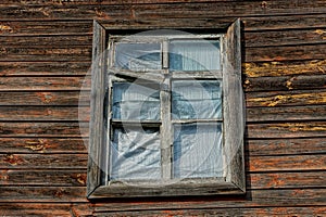One old window on a brown wooden  wall