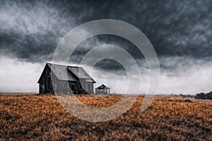 one old wooden abandoned house in a field, ranch, dark dramatic sky, autumn nature as background