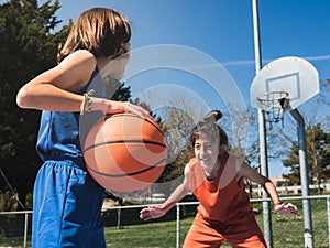 One-on-one basketball between two boys