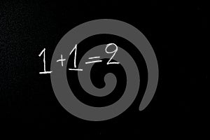 One and one equals two on blackboard