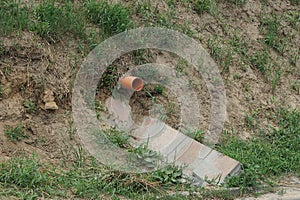 One orange plastic pipe for draining sewers and dirty water