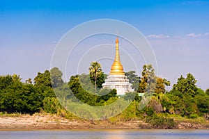 One pagoda on the banks of the Irrawaddy river, Mandalay, Myanmar, Burma. Copy space for text.