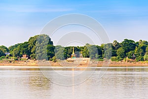 One pagoda on the banks of the Irrawaddy river, Mandalay, Myanmar, Burma. Copy space for text.