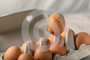 One pained egg standing apart from others eggs. concept of racism, intolerance, denial of society