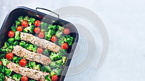 One pan dish, baked salmon fillet with broccoli and tomato, horizontal, top view, copy space