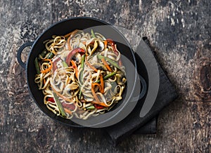 One pan yaki udon noodles with stir fry vegetables. Vegetarian noodles with green beans, sweet peppers, mushrooms, carrots - healt