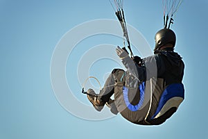 One paragliding in blue sky