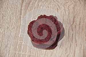 one pastry food for cat. appetizing dog muffins on wooden background. dog birthday. red velvet. paw shaped dog treat. homemade pet