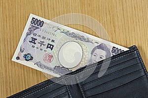 One peice of five thousand Japanese cashes wallet close up photo
