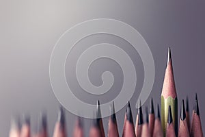 One pencil standing out from the group of other pencil