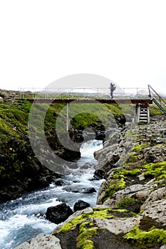 One person crossing the wooden bridge at the start of stage two of FimmvÃ¶rduhals mountain pass, Iceland