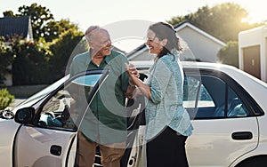 One person helping another makes a difference. a woman helping her senior father out the car.