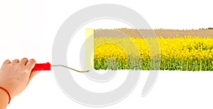 One person painting a landscape with yellow flowers on a white wall with a roller brush