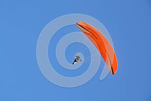 One person safely flies on a paraglider.