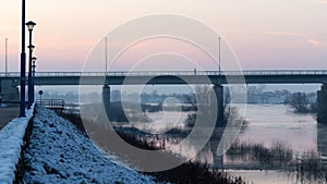 One person walks across bridge during twilight