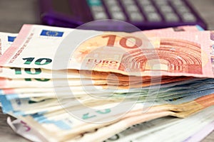 Euro banknotes and a calculator