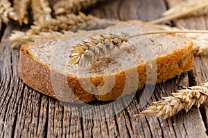 One piece of bread on wooden table