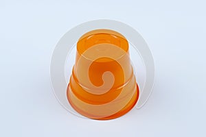 One piece orange plastic cup on white background