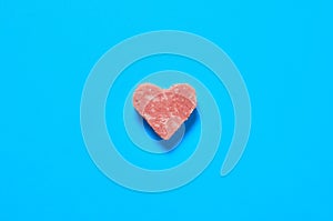 One piece of sausage in form of heart. Valentines day concept