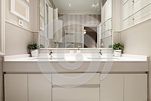 One-piece washbasin with two sinks and two taps in the bathroom