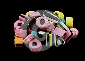 One pile of liquorice allsorts candy isolated on black background