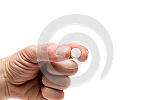 One pill in the hands of a man, hand isolate with the pill on a white background.