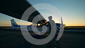 One pilot wiping an airplane`s fuselage, close up.