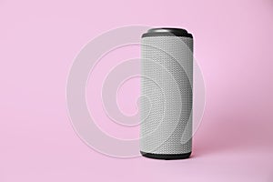 One portable bluetooth speaker on pink background, space for text. Audio equipment