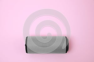 One portable bluetooth speaker on pink background, top view with space for text. Audio equipment