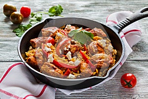 One-pot chicken fillet and orzo pasta with red bell peppers and feta cheese, cooked with garlic, paprika and olive oil.