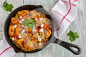 One-pot chicken fillet and orzo pasta on wooden table, top view.