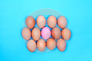 One preserved egg on blue background with chicken egg