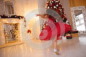 One pretty little girl with blonde hair wearing red, sparkly Christmas dress