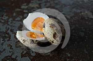 One quail egg open one still closed