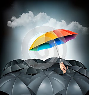 One rainbow umbrella standing out on a grey background.