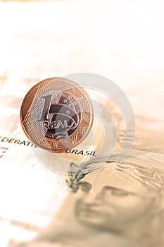 One real coin and gold bars. Concept of appreciation of the Brazilian currency in the stock market photo