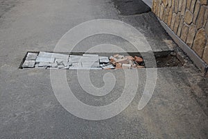 One rectangular pit pothole on the asphalt road