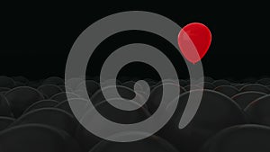 One red balloon is opposed by many other balloons. Dark background. Ideal title text background. One against all