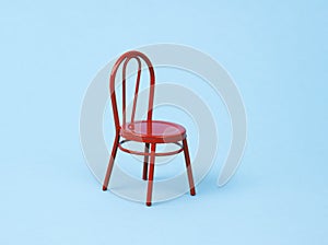 One red chair on a blue background. Head hunting and loneliness minimal concept