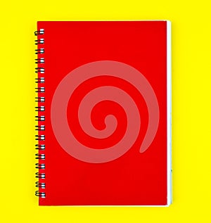 One red colored note paper diary placed on a isolated yellow background