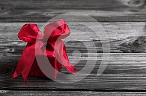 One red festive christmas present on wooden shabby background.