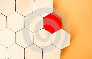 One red hexagon stands out from the rest. Leadership and victory concept. Dissimilarity and dissent. Uniqueness initiative. photo