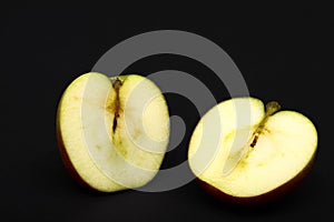 One red ripe apple sliced in half