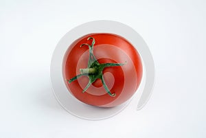 One red ripe tomato on a white background
