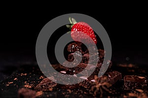 One red straberry on a dark chocolate