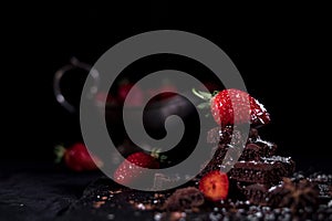 One red straberry on a dark chocolate