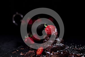 One red straberry on a dark chocolate